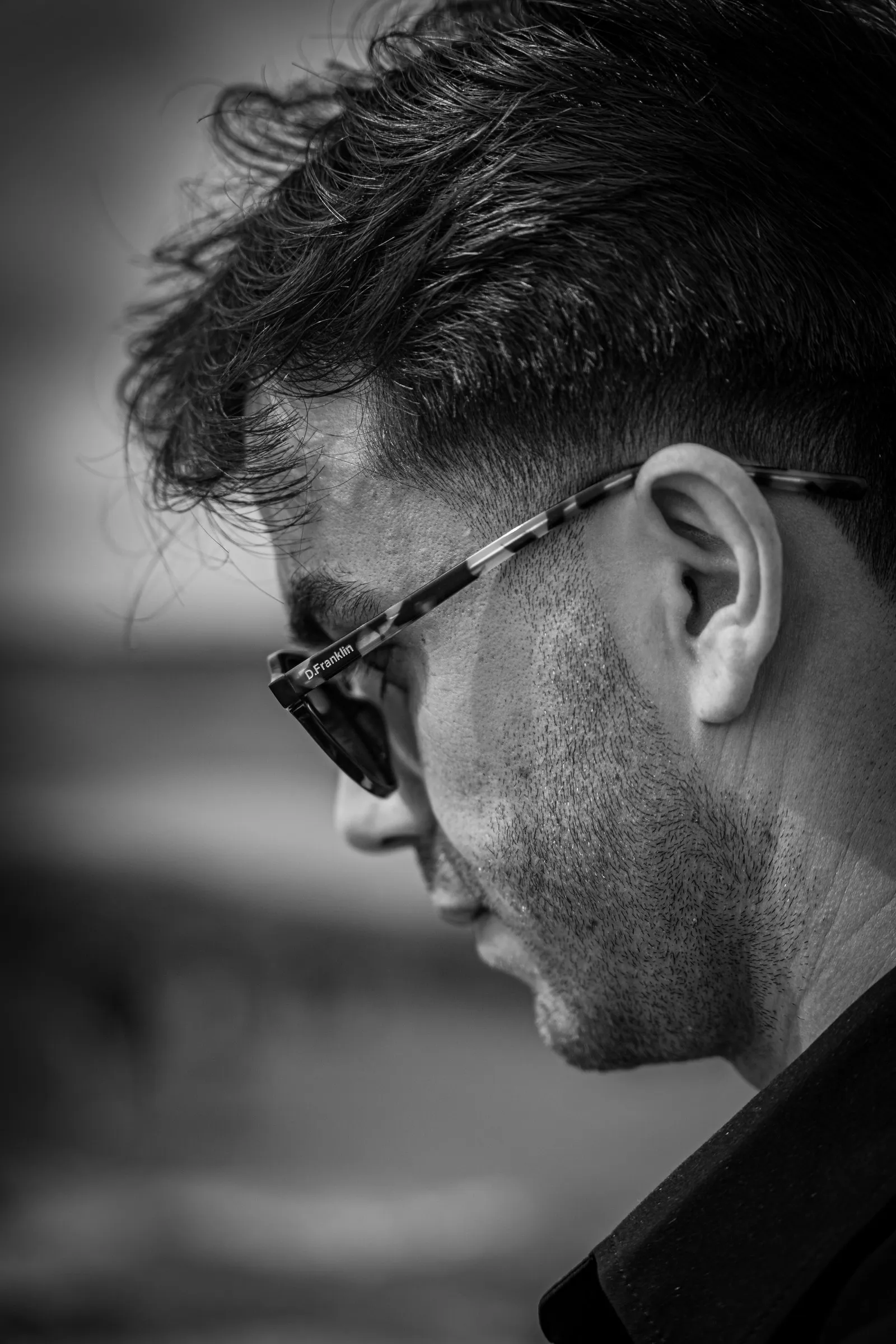 Black and white profile portrait of a man in sunglasses