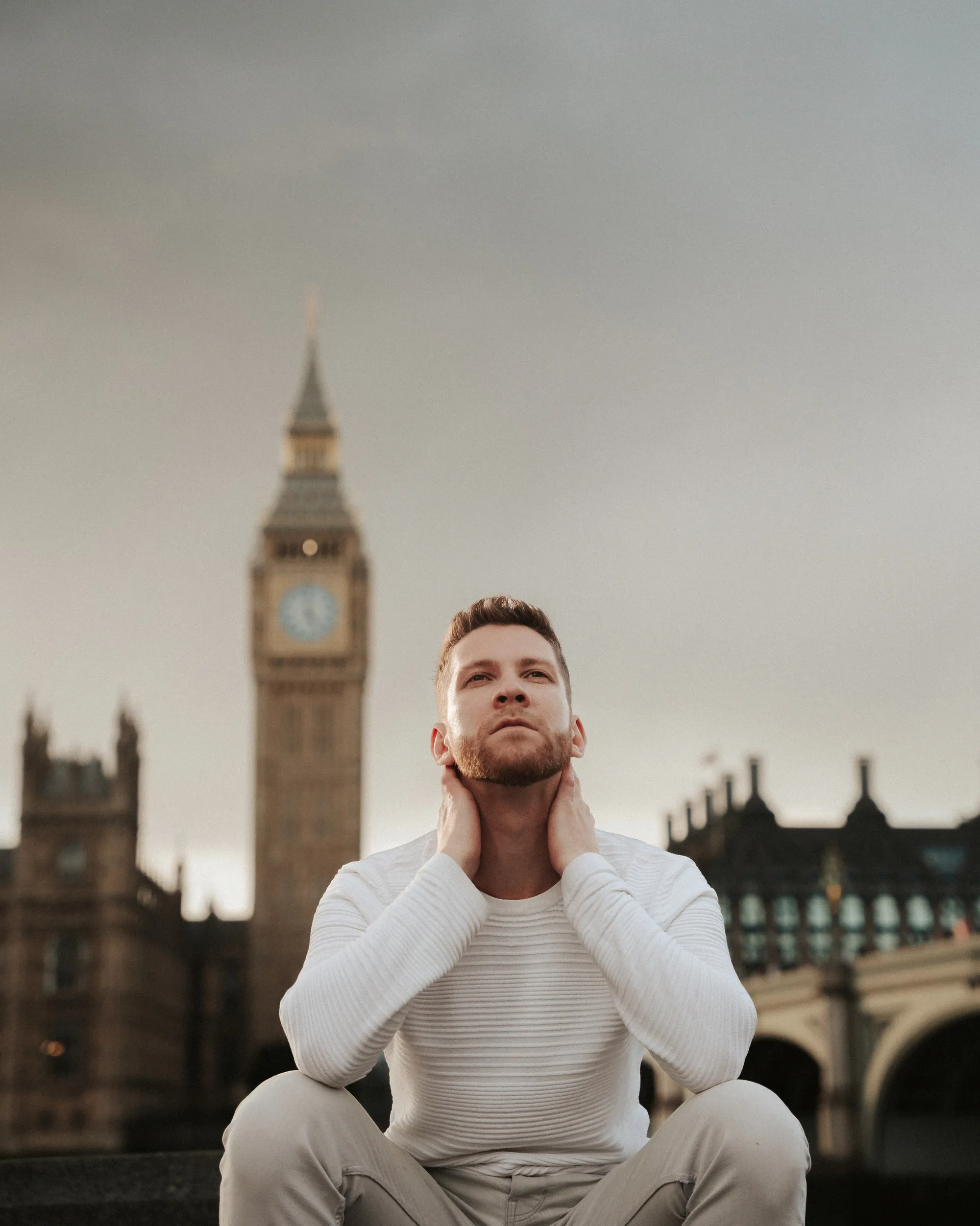 Portrait of a man seated with Big Ben and Westminster Bridge behind him