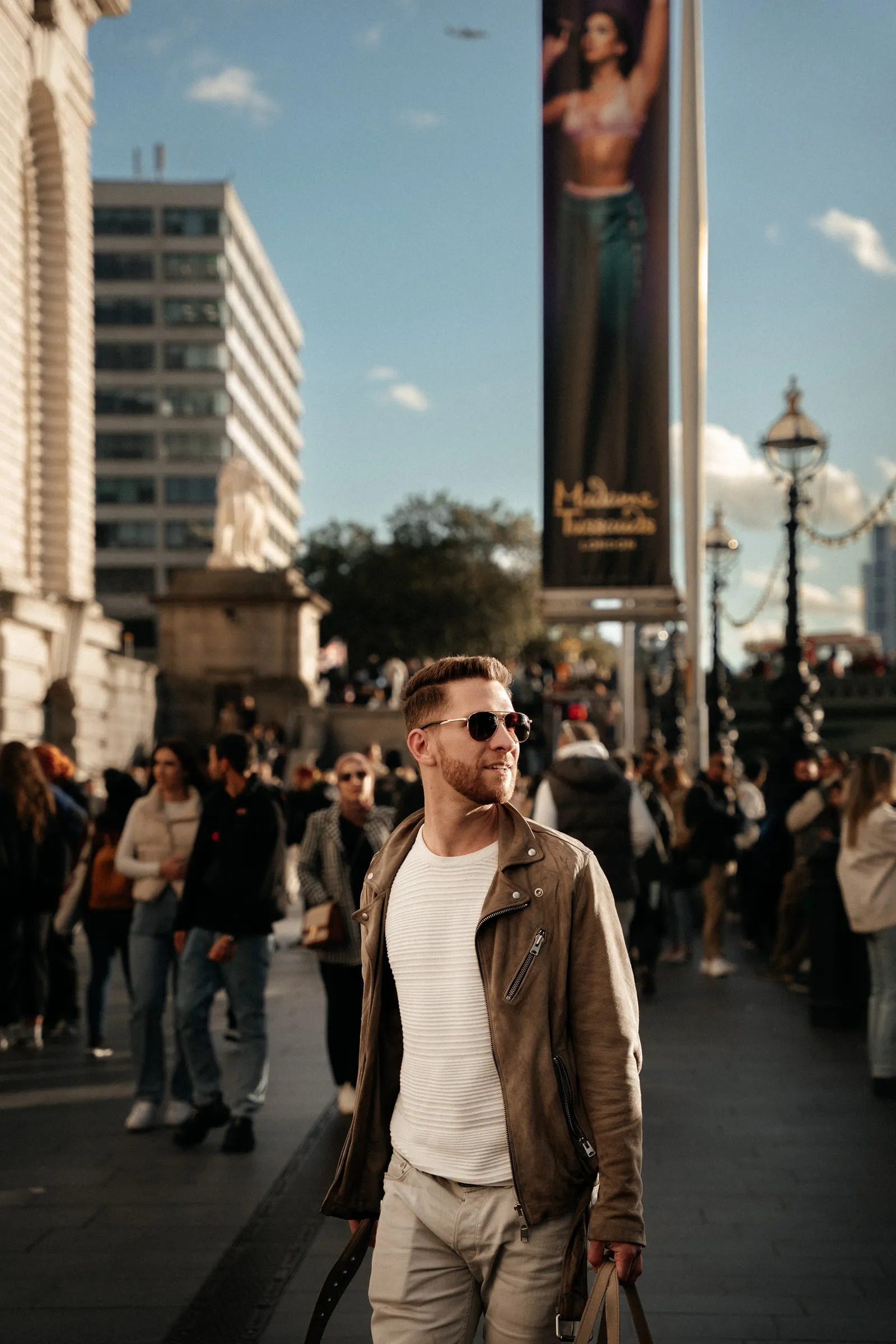 A man walking towards camera through a crowded London street